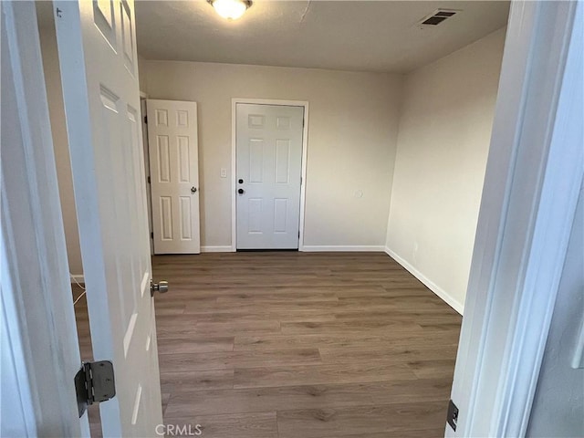 hallway featuring wood-type flooring