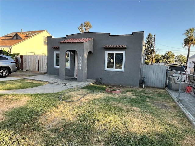 mediterranean / spanish house with a front lawn