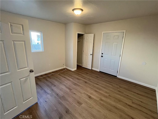 unfurnished bedroom with dark hardwood / wood-style floors