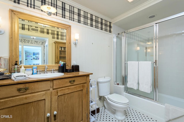 full bathroom with enclosed tub / shower combo, crown molding, vanity, and toilet