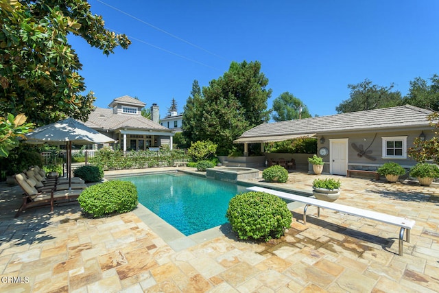 view of pool featuring an in ground hot tub, a patio area, and a diving board