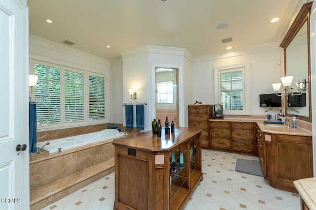 bathroom with vanity, tiled bath, crown molding, and a notable chandelier