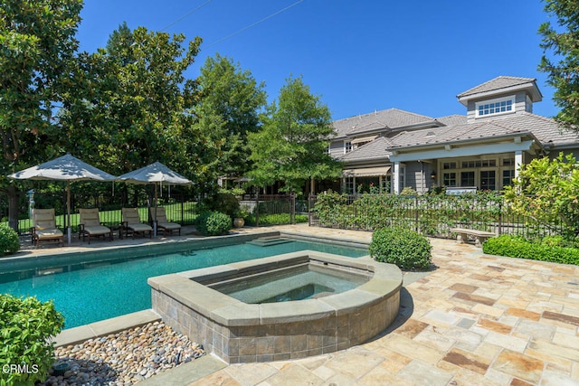 view of pool with an in ground hot tub and a patio area