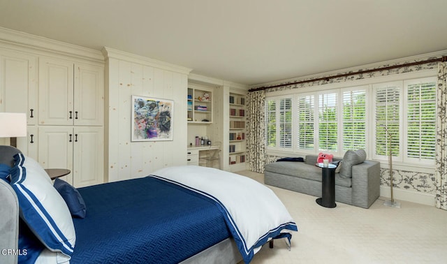 carpeted bedroom with ornamental molding and a closet