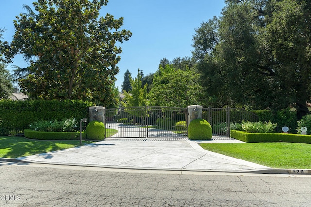 view of gate featuring a yard