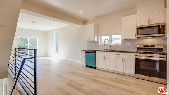 kitchen with a healthy amount of sunlight, light wood-type flooring, and appliances with stainless steel finishes