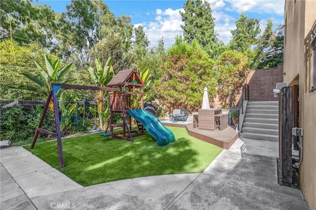 view of play area with a patio and a yard