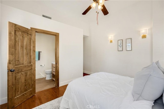 bedroom with ceiling fan, hardwood / wood-style floors, and ensuite bath