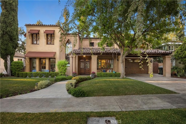 mediterranean / spanish-style home with a front yard