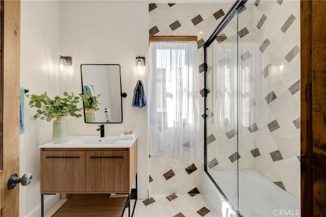 bathroom featuring vanity and enclosed tub / shower combo