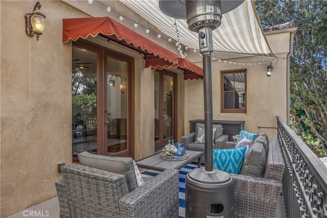 view of patio / terrace with a balcony and french doors