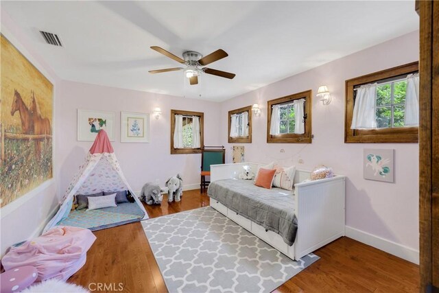 bedroom with ceiling fan and hardwood / wood-style floors