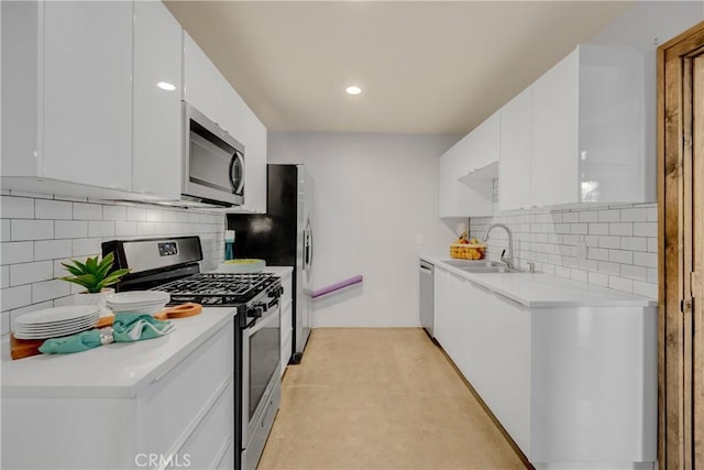 kitchen with sink, white cabinetry, and stainless steel appliances