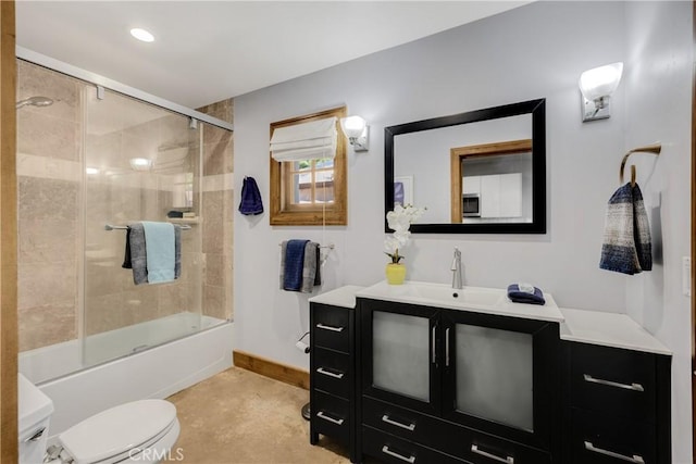 full bathroom featuring combined bath / shower with glass door, toilet, and vanity