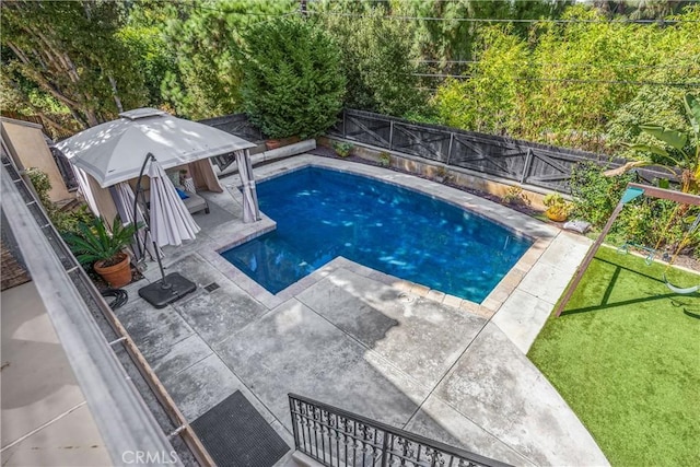 view of pool featuring a patio and a lawn