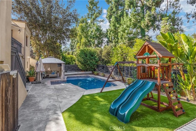 view of swimming pool with outdoor lounge area, a patio area, a lawn, and a playground