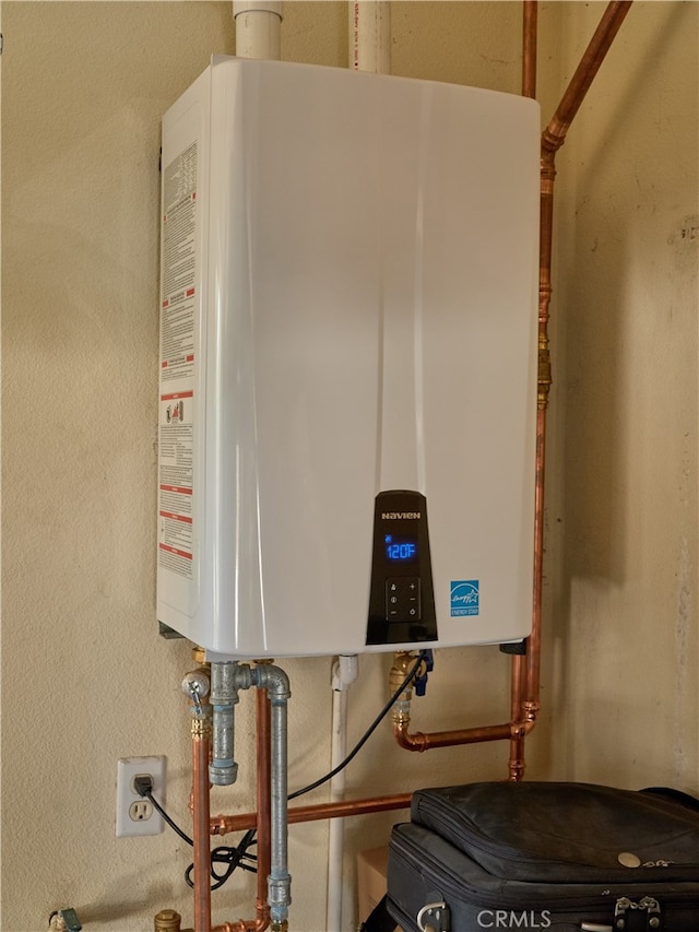 utility room with tankless water heater