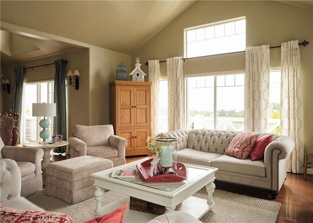 living room featuring vaulted ceiling, dark hardwood / wood-style flooring, and plenty of natural light