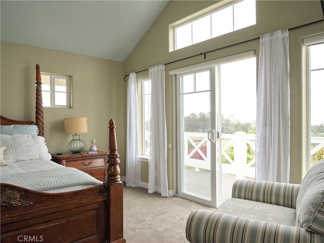 carpeted bedroom with vaulted ceiling, access to exterior, and multiple windows