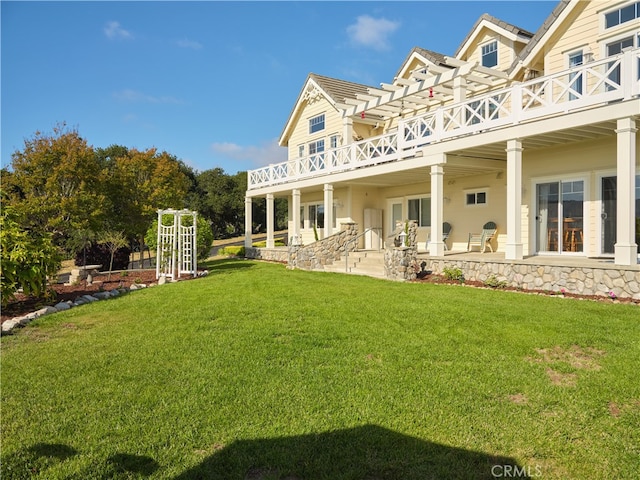 rear view of house with a lawn and a patio area