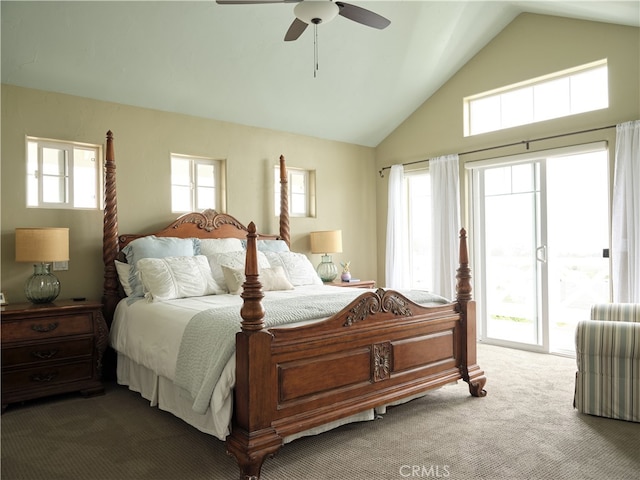 carpeted bedroom with vaulted ceiling and multiple windows