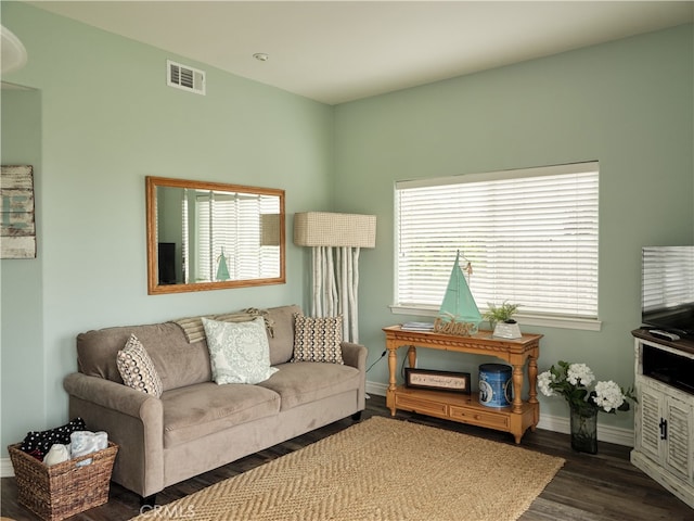 living room with dark hardwood / wood-style floors and plenty of natural light