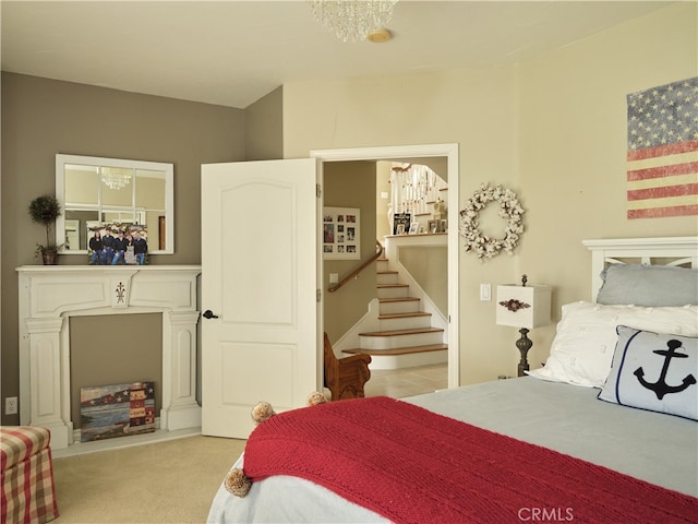 carpeted bedroom with an inviting chandelier