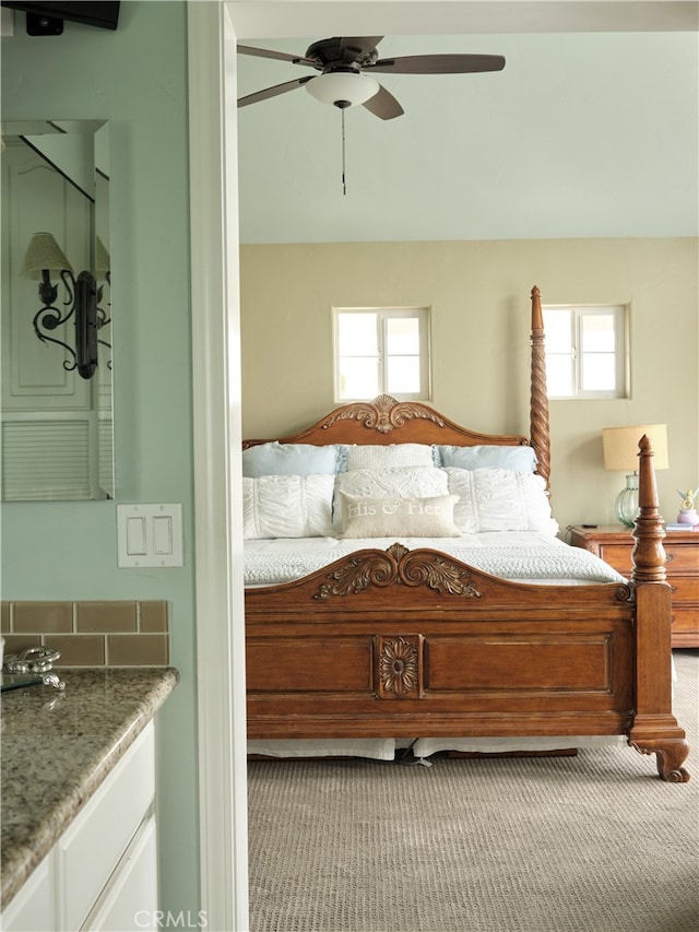 bedroom with ceiling fan and light colored carpet