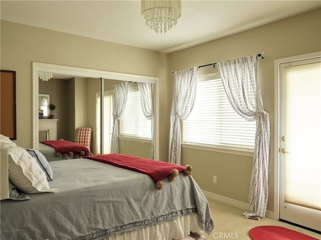 bedroom with an inviting chandelier and carpet flooring