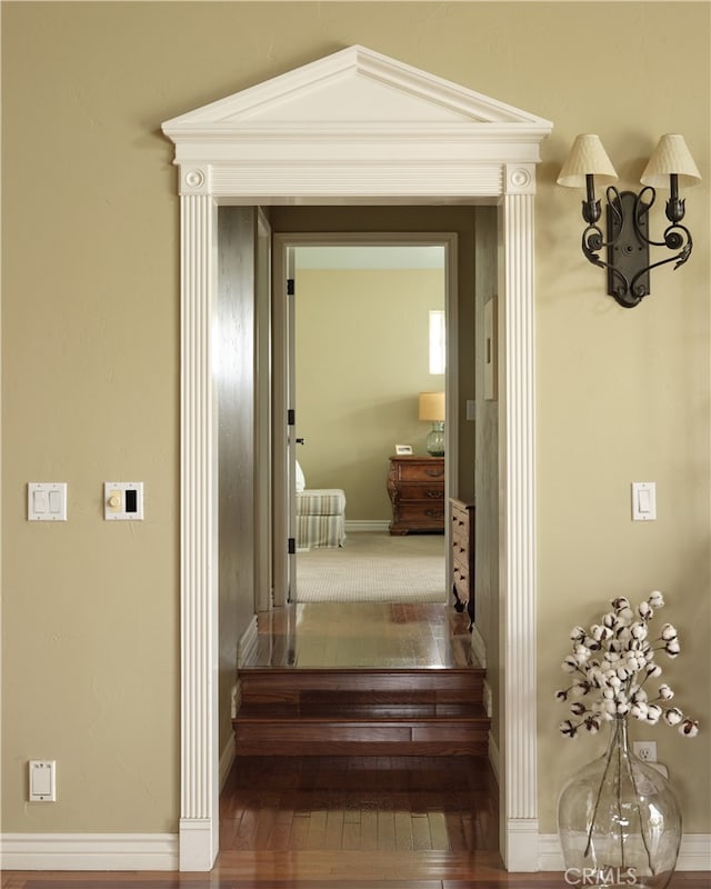 corridor featuring wood-type flooring and lofted ceiling