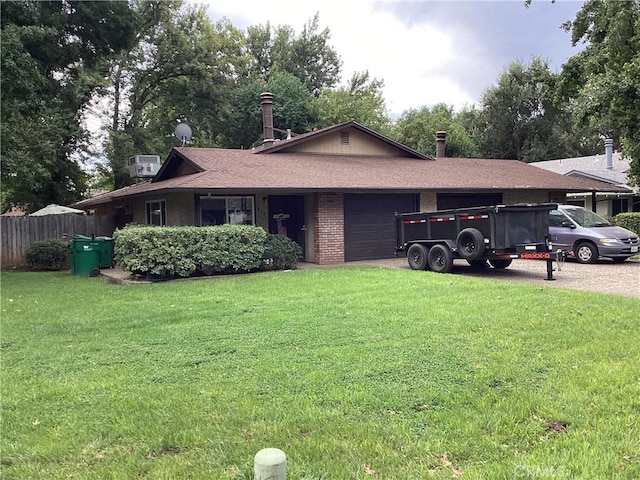 single story home featuring a front lawn and a garage