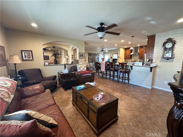 living room featuring light tile patterned flooring and ceiling fan