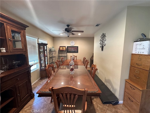 tiled dining area featuring ceiling fan