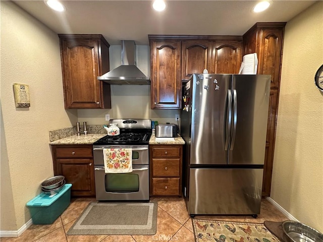10693 Valencia St, Bloomington, CA 92316 - kitchen with stainless steel appliances, wall chimney range hood, light tile patterned flooring, baseboards, and recessed lighting