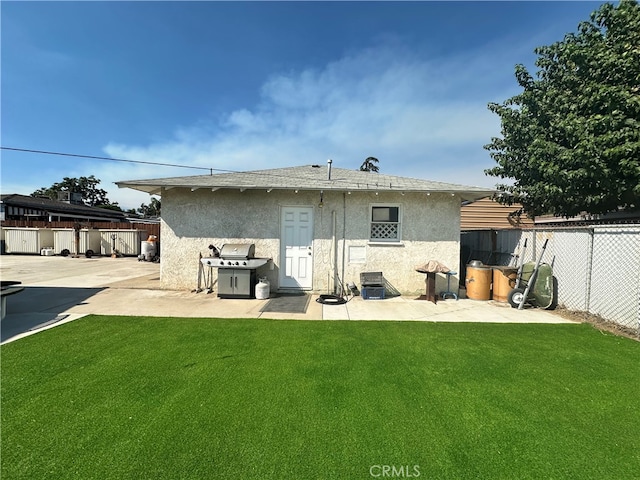 rear view of house featuring a patio area and a yard