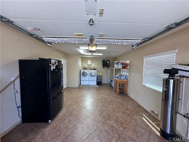 10693 Valencia St, Bloomington, CA 92316 - garage with freestanding refrigerator, washing machine and dryer, and a garage door opener