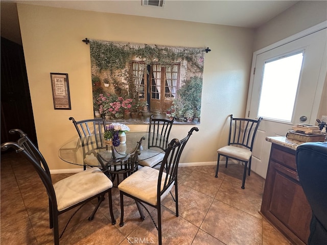 dining space with light tile patterned flooring