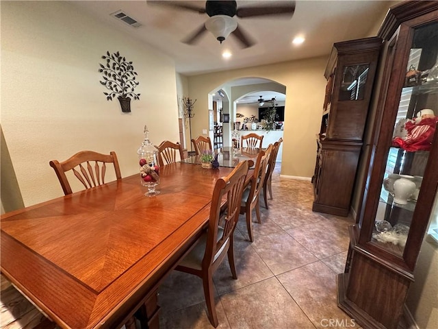10693 Valencia St, Bloomington, CA 92316 - dining room featuring ceiling fan, arched walkways, light tile patterned floors, recessed lighting, and baseboards