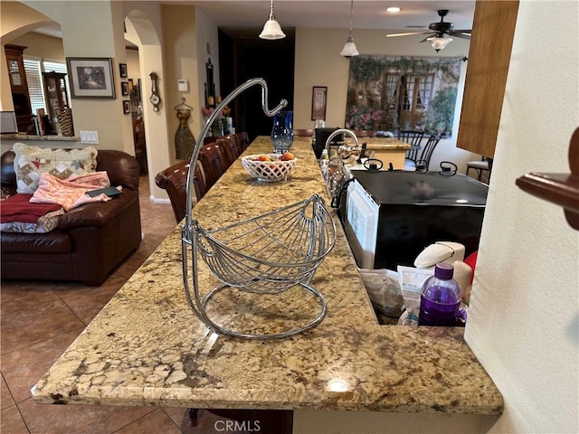 10693 Valencia St, Bloomington, CA 92316 - dining room featuring arched walkways, ceiling fan, and tile patterned floors