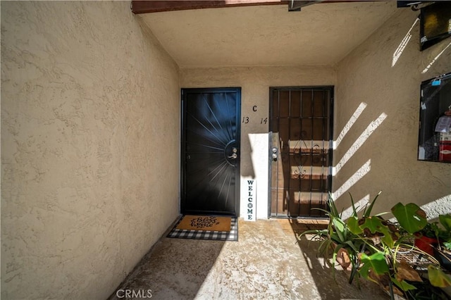 doorway to property with stucco siding