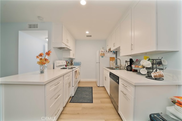 kitchen with stainless steel appliances, light wood-type flooring, and white cabinetry