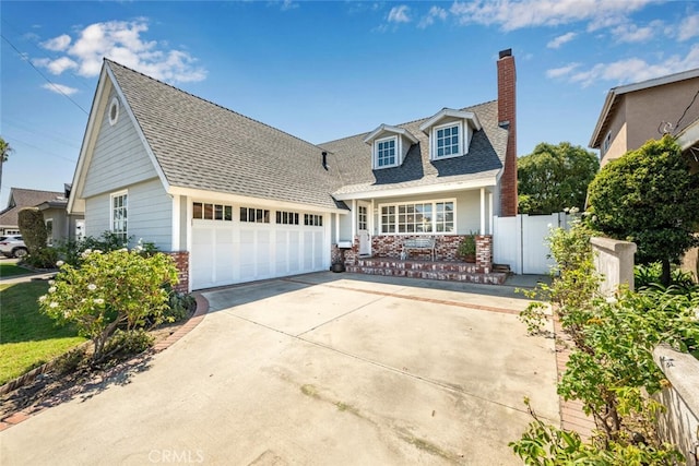 new england style home with a garage