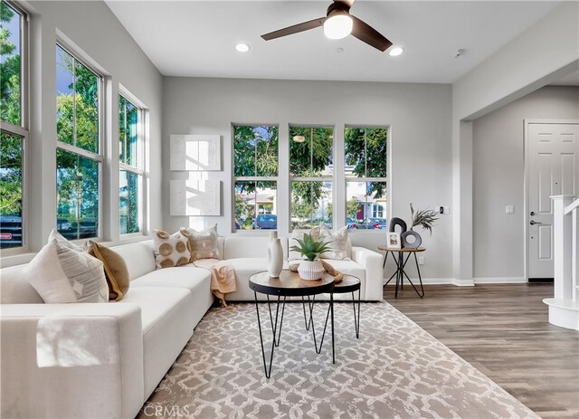 living room with ceiling fan, hardwood / wood-style flooring, and a healthy amount of sunlight