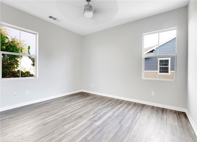 empty room featuring ceiling fan and light hardwood / wood-style flooring