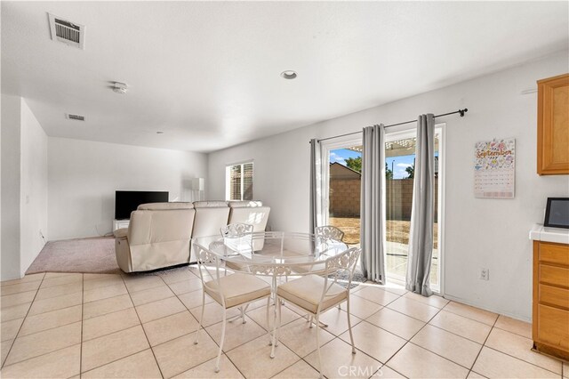 dining area with light tile patterned floors