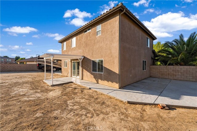 rear view of property featuring a patio