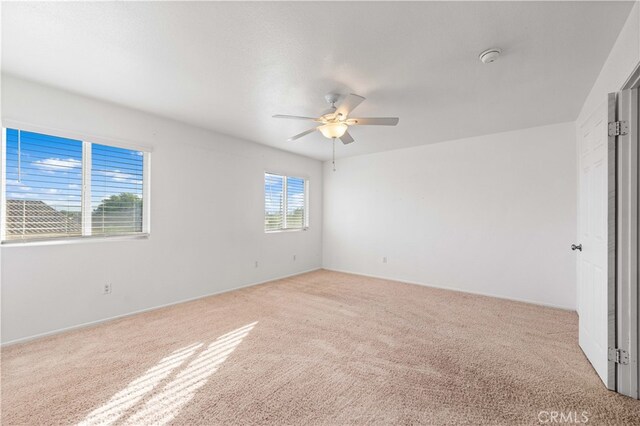 unfurnished room with ceiling fan and light colored carpet