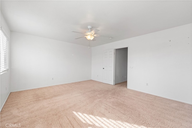 spare room with light carpet and ceiling fan