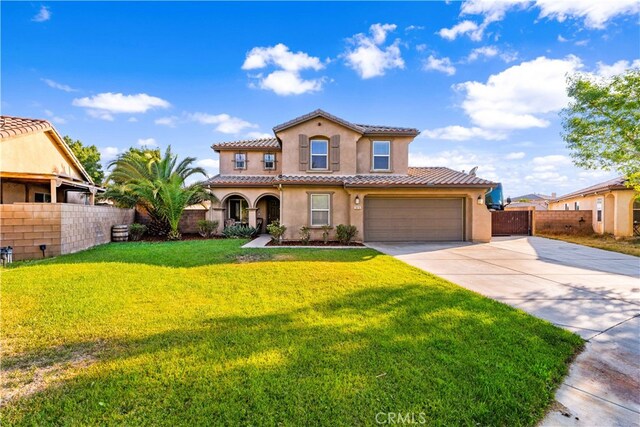 mediterranean / spanish-style home with a garage and a front yard