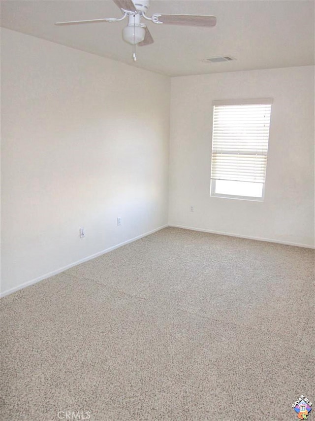 carpeted empty room featuring ceiling fan